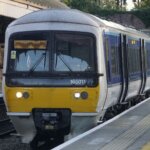 Yellow and blue train pulling into platform